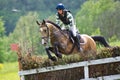 Eventer horseback jump overcomes cross-country fen Royalty Free Stock Photo