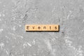 Events word written on wood block. Events text on cement table for your desing, concept Royalty Free Stock Photo