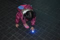 Young Asian girl curious about light in the floor.