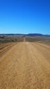 Ever ending very long dirt road in the Australian desert Royalty Free Stock Photo