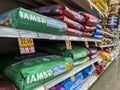 Everett, WA USA - circa June 2022: Angled close up of large bags of dry dog food for sale inside a Fred Meyer grocery store