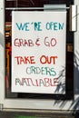 Closed Downtown Business signs advertising grab and go take out food due to state mandated Royalty Free Stock Photo