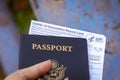 Hand Holding an American Passport and Covid Vaccination Card