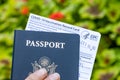 Hand Holding an American Passport and Covid Vaccination Card