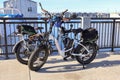 Two electric bicycles at the Port Of Everett Marina on a sunny day