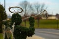 Evergreen angel sculpture playing a trumpet