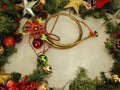Evergreen branch frame with Christmas decorations.. jingle bells, gold, silver stars, pine cones Royalty Free Stock Photo