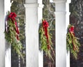 Evergreen Christmas Branches Hanging on White Pillars Royalty Free Stock Photo