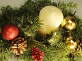 Evergreen decoration, white candle, red sparkle ball, gold balls, pine cone Royalty Free Stock Photo