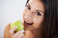 Every bite is delicious. Portrait of an attractive young woman eating a green apple.