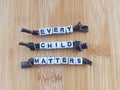 Every child matters message on a wood background