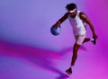 Every day is a chance to get better. Purple filtered shot of a sporty young man playing basketball.