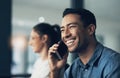 Every disadvantage has its advantage. a happy young man chatting on a cellphone in a modern office. Royalty Free Stock Photo