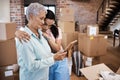Every home has a history. Shot of a senior woman looking at a photograph with her daughter while packing boxes on moving Royalty Free Stock Photo