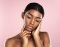 Every inch of her skin is silky smooth. Studio shot of a beautiful young woman posing with her eyes closed against a Royalty Free Stock Photo