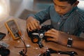 Every kid is a genius at something. a handsome young boy building a robotic toy car at home.