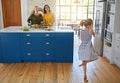 Every mealtime is special with family. a little girl dancing while her mother and grandmother cooks in the background.