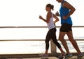 Every mile is worth it. a young couple jogging together on the promenade. Royalty Free Stock Photo