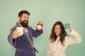 Every morning begins with coffee. Couple in bathrobes with mugs. Man with beard and sleepy woman enjoy morning coffee or Royalty Free Stock Photo