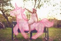 Every princess rides away into the sunset on a unicorn. Shot an adorable little girl riding a pink toy unicorn outdoors. Royalty Free Stock Photo