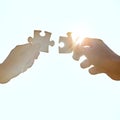 Every puzzle has a solution. A cropped shot of hands holding puzzle pieces. Royalty Free Stock Photo