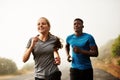 Every step you take is one to be proud of. two sporty young people out for a run together. Royalty Free Stock Photo