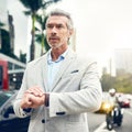 Every successful entrepreneur keeps a strict eye on time. Shot of a mature businessman checking the time on his wrist Royalty Free Stock Photo