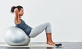 Every workout is a step closer to your goal. a young woman exercising using a fitness ball.