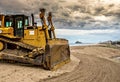 The beach is prepared for the season with a small excavator