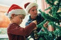 Everybodys favourite Christmas tradition. an adorable little boy decorating the Christmas tree with his father at home. Royalty Free Stock Photo