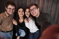 Everyboy is smiling. Taking selfie. Close up front view of friends. Man in sunglasses in the room Royalty Free Stock Photo