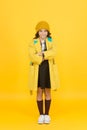 Everyday is fashion show. Little schoolchild in autumn fashion yellow background. Small vogue model with cute fashion