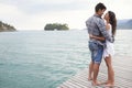 Everyday is a holiday when were together. an affectionate young couple standing together on a jetty. Royalty Free Stock Photo