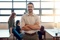 Everyday my staff makes a difference. Portrait of a confident mature businessman standing in a modern office with his Royalty Free Stock Photo