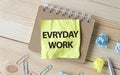 Everyday work. Text on white paper on wooden Royalty Free Stock Photo