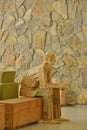 Everyman look wood sculpture blends into the stonework Royalty Free Stock Photo