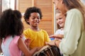 Everyone loves music. a woman teaching her class about musical instruments. Royalty Free Stock Photo