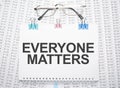 Everyone Matters text written on paper with pen and glasses Royalty Free Stock Photo