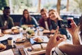 Everyone move in for a quick snap. a woman taking a picture of colleagues having a business lunch. Royalty Free Stock Photo