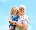 Everyone needs a granddad. Portrait of a happy grandfather holding his young granddaughter. Royalty Free Stock Photo