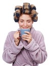 Everyone one needs help in the morning. Studio shot of a woman with curlers in her hair and wearing a robe drinking Royalty Free Stock Photo