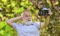 Everyone photogenic. Senior man taking selfie photo vintage camera. Self portrait. Memories in snap. Retro equipment for Royalty Free Stock Photo