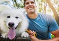 Everyone should have such a loyal friend. a handsome young man walking his dog in the park. Royalty Free Stock Photo