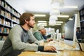 Everyone is studying during exam season. a young male university student studying in the library. Royalty Free Stock Photo