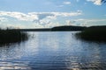 Endless expandes of the lake Seliger and glossy water surface under the blinding sunlight. Tver region, Russia.