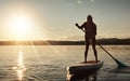 Everything changes when your board touches the water. an attractive young woman paddle boarding on a lake.