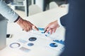 Everything detailed and accounted for. two unrecognizable businessmen discussing paperwork at the table in the boardroom