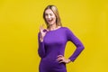 Everything is fine. Portrait of playful positive woman showing ok gesture. indoor studio shot isolated on yellow background