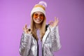 Everything fine thanks. Charming flirty blond confident woman in silver stylish jacket sunglasses winter hat show okay