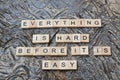 everything is hard before it is easy text on wooden square, motivation quotes Royalty Free Stock Photo